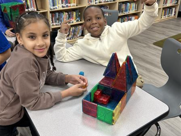 boy and girl building with magnatiles